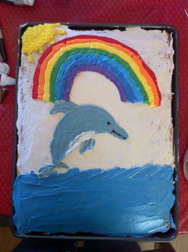 A festive dolphin celebrating with a birthday cake and balloon on Craiyon